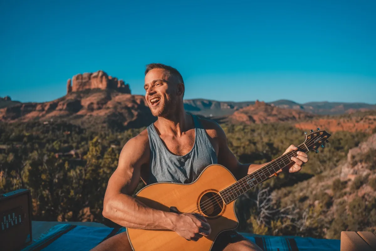 Jack Rosenkrantz playing guitar and laughing in Sedona